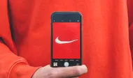 person holding iPhone taking picture on Nike label