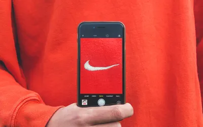person holding iPhone taking picture on Nike label